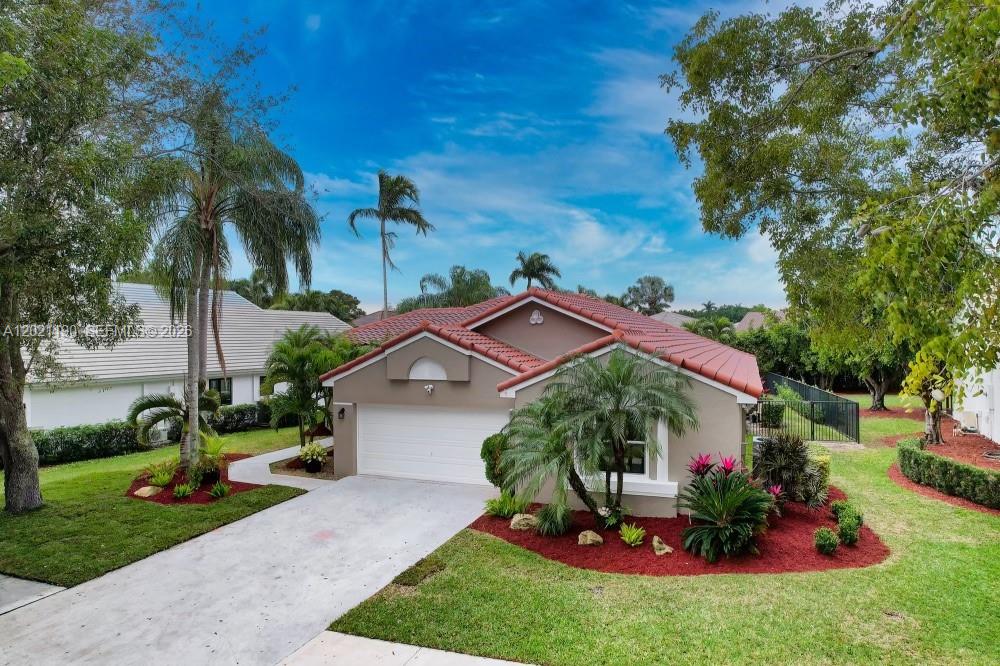 814 Heron Road Weston, FL 33326 - Photo 1 of 27 a view of a house with a yard and tree s