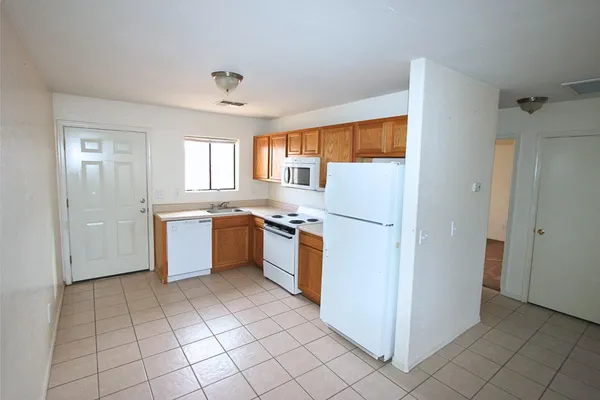a kitchen with a stove sink and refrigerator