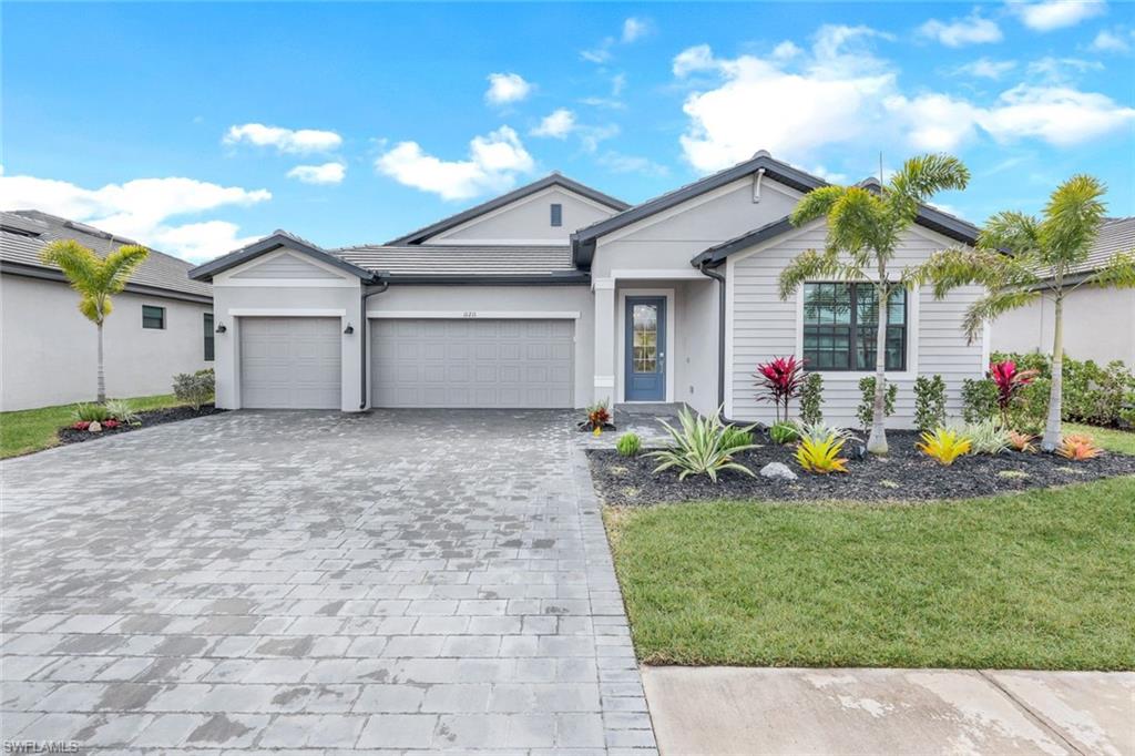 11211 Canopy Loop Fort Myers, FL 33913 - Photo 1 of 49 View of front facade with a garage and a front lawn