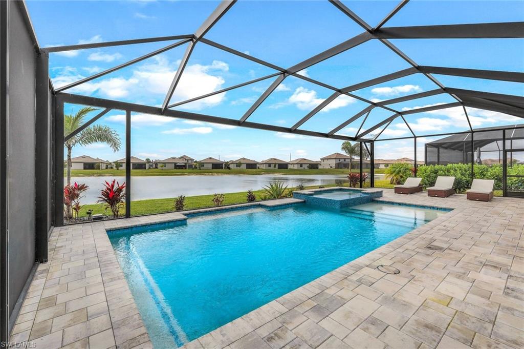11211 Canopy Loop Fort Myers, FL 33913 - Photo 2 of 49 View of swimming pool featuring a water view, an in ground hot tub, a lanai, and a patio