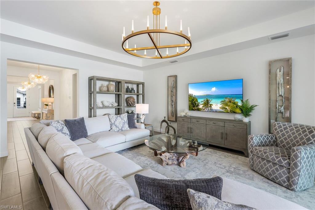 11211 Canopy Loop Fort Myers, FL 33913 - Photo 4 of 49 Living room with a notable chandelier and a tray ceiling