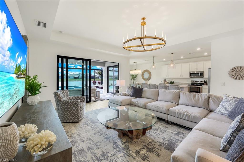11211 Canopy Loop Fort Myers, FL 33913 - Photo 5 of 49 Living room with a notable chandelier and a tray ceiling