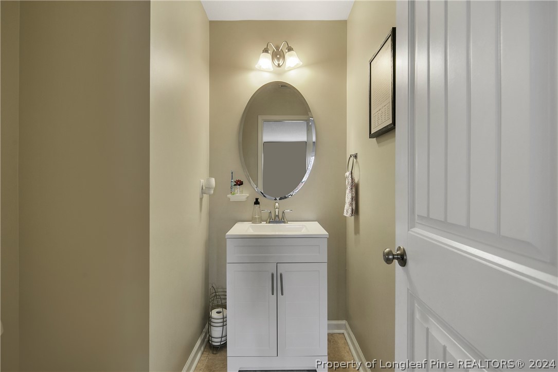 Undisclosed Address Hope Mills, NC 28348 - Photo 12 of 46 a bathroom with a sink and mirror with shower