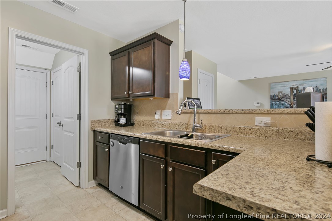 Undisclosed Address Hope Mills, NC 28348 - Photo 16 of 46 a kitchen with a sink a counter space and stainless steel appliances