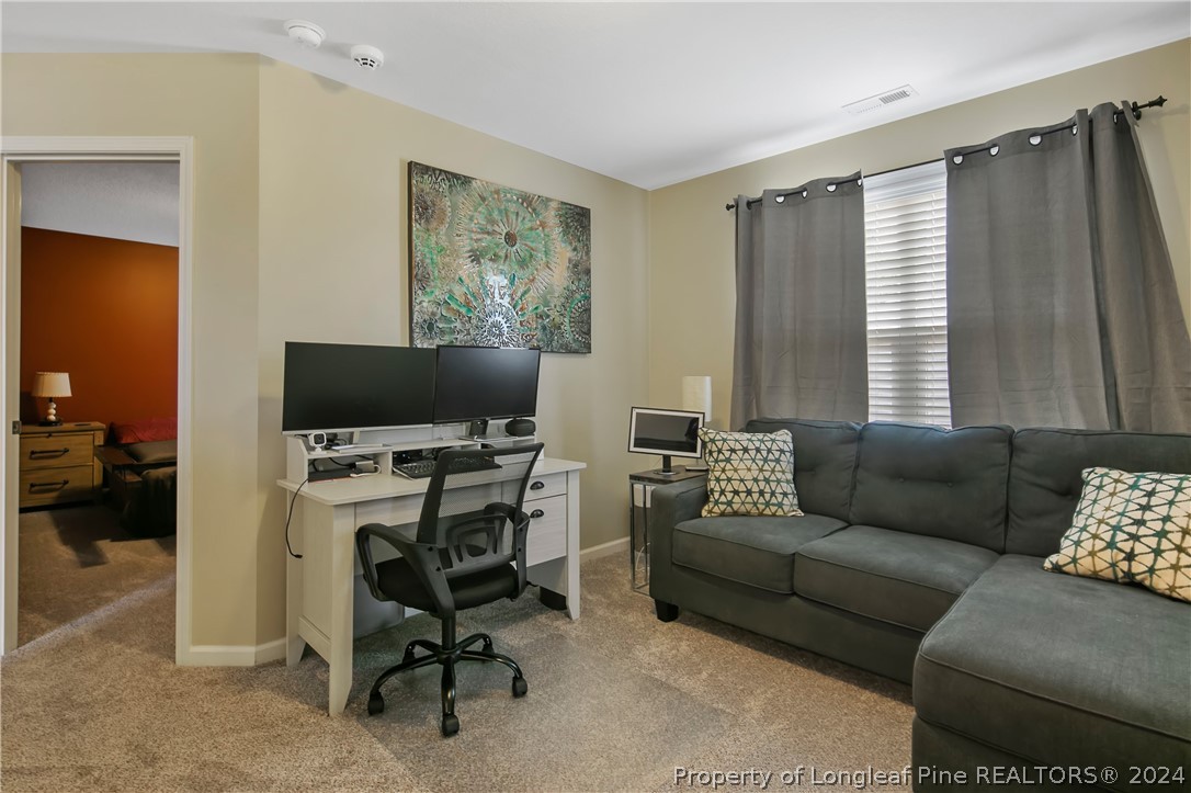 Undisclosed Address Hope Mills, NC 28348 - Photo 25 of 46 a livingroom with workspace and a couch