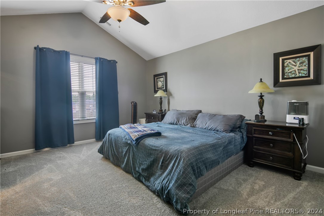 Undisclosed Address Hope Mills, NC 28348 - Photo 26 of 46 a bedroom with a bed and ceiling fan