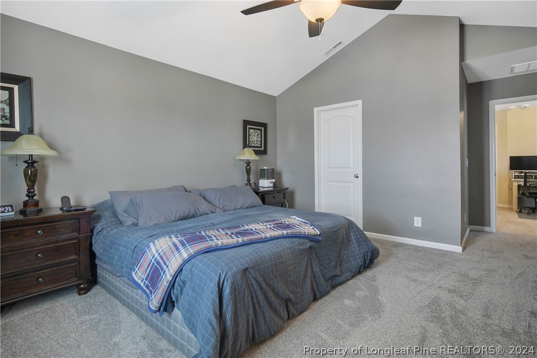 Undisclosed Address Hope Mills, NC 28348 - Photo 27 of 46 a bedroom with a bed and a lamp on dresser