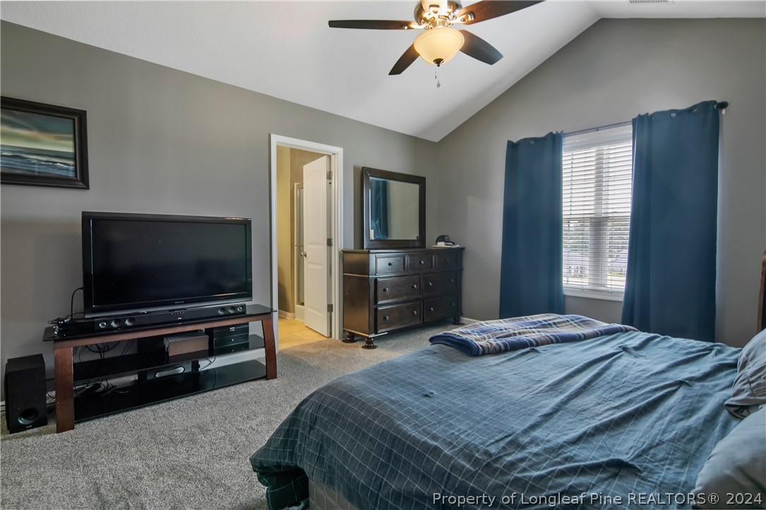Undisclosed Address Hope Mills, NC 28348 - Photo 29 of 46 a bedroom with a bed and a flat screen tv