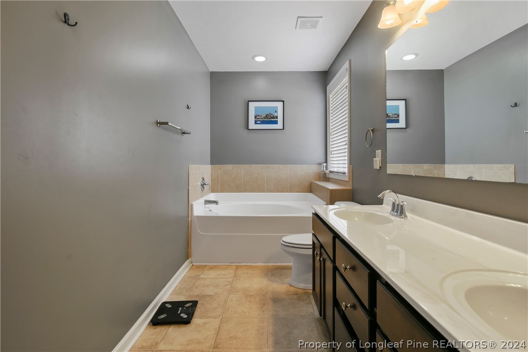 Undisclosed Address Hope Mills, NC 28348 - Photo 31 of 46 a bathroom with a sink a toilet and bathtub