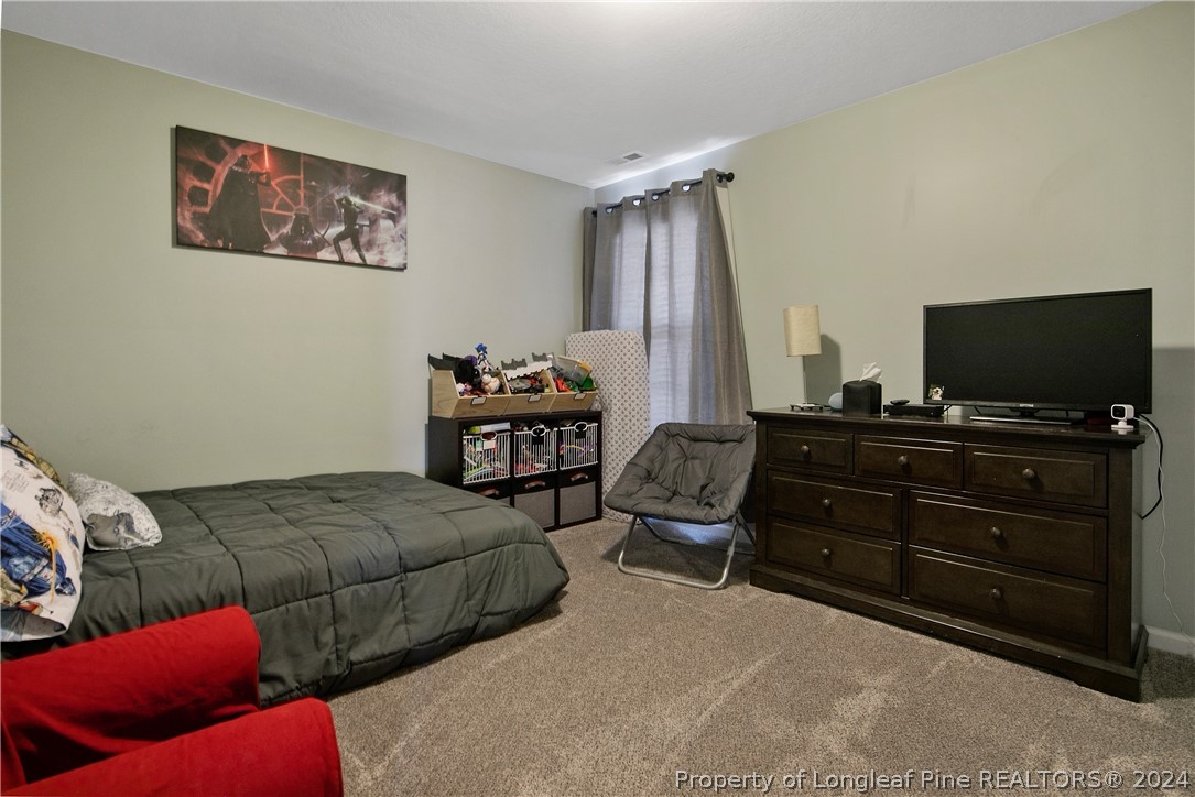 Undisclosed Address Hope Mills, NC 28348 - Photo 34 of 46 a bedroom with furniture and a flat screen tv