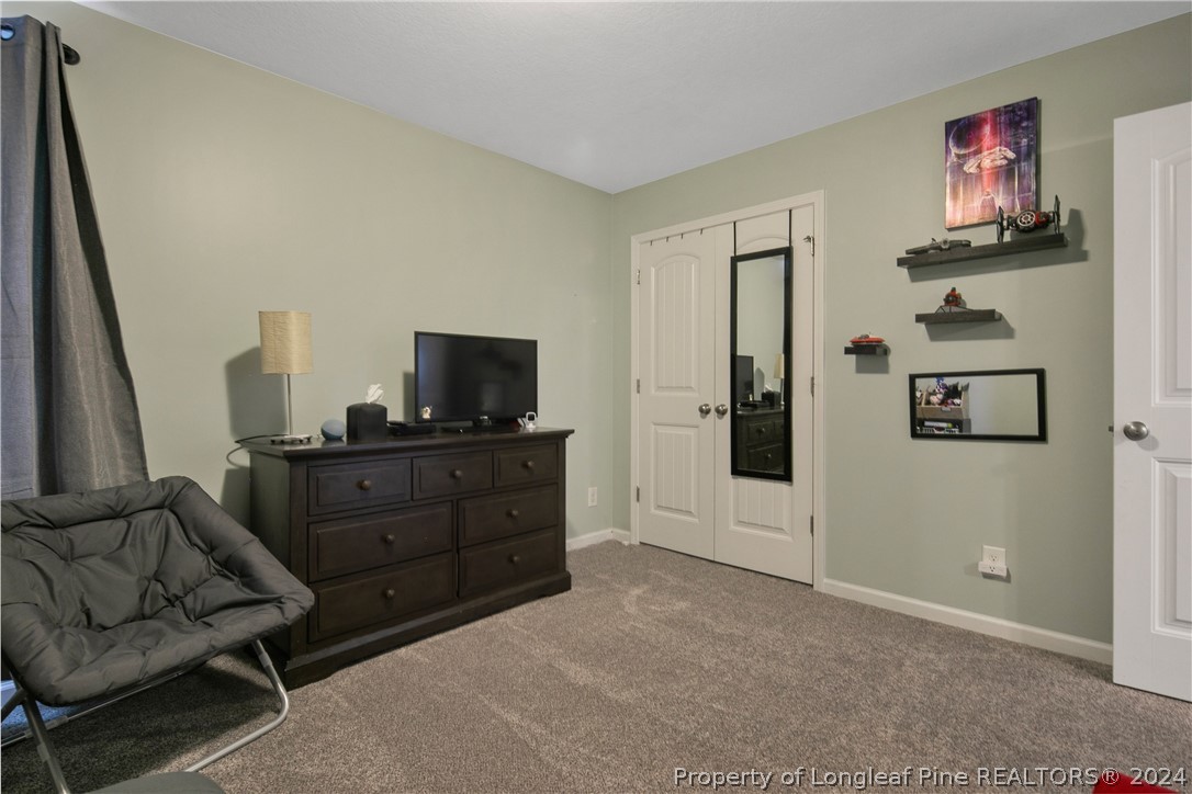 Undisclosed Address Hope Mills, NC 28348 - Photo 35 of 46 a living room with furniture and a flat screen tv