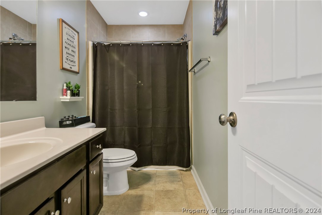 Undisclosed Address Hope Mills, NC 28348 - Photo 38 of 46 a bathroom with a sink a toilet a mirror and shower