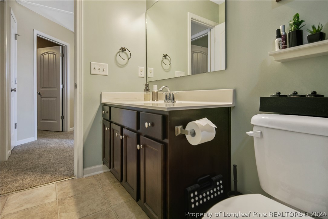 Undisclosed Address Hope Mills, NC 28348 - Photo 39 of 46 a bathroom with a sink a toilet and a mirror