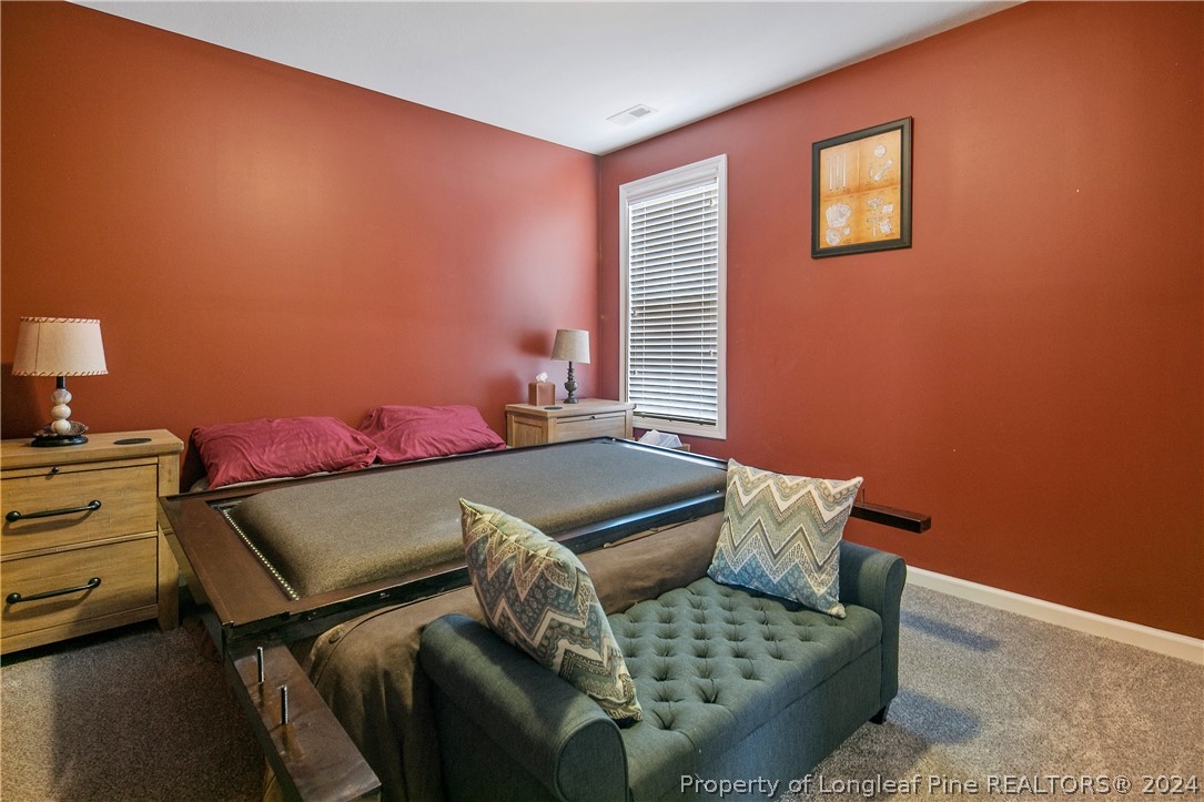 Undisclosed Address Hope Mills, NC 28348 - Photo 40 of 46 a bedroom with a bed and wooden floor