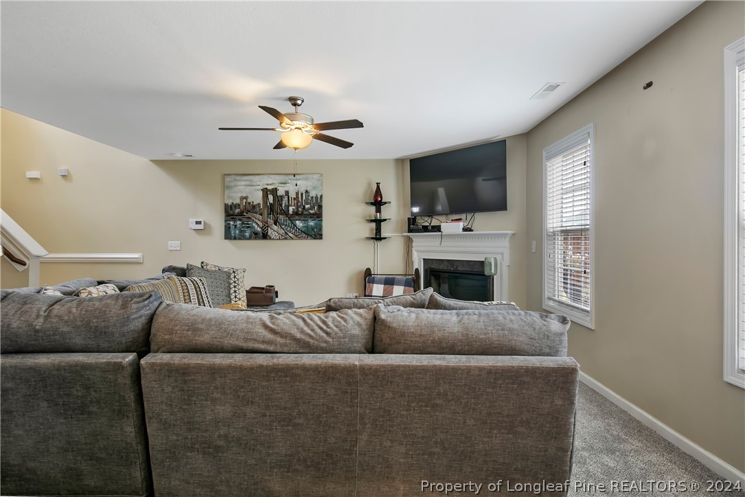 Undisclosed Address Hope Mills, NC 28348 - Photo 10 of 46 a living room with furniture a fireplace and a flat screen tv