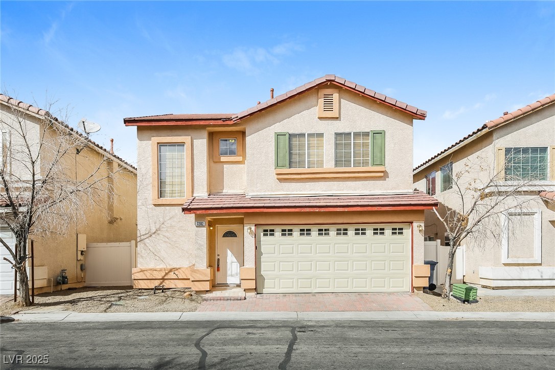 7202 Cestrum Road Las Vegas, NV 89113 - Photo 1 of 15 View of front of home with an attached garage, stu