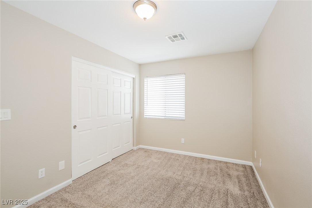 7202 Cestrum Road Las Vegas, NV 89113 - Photo 10 of 15 Unfurnished bedroom with a closet, carpet flooring