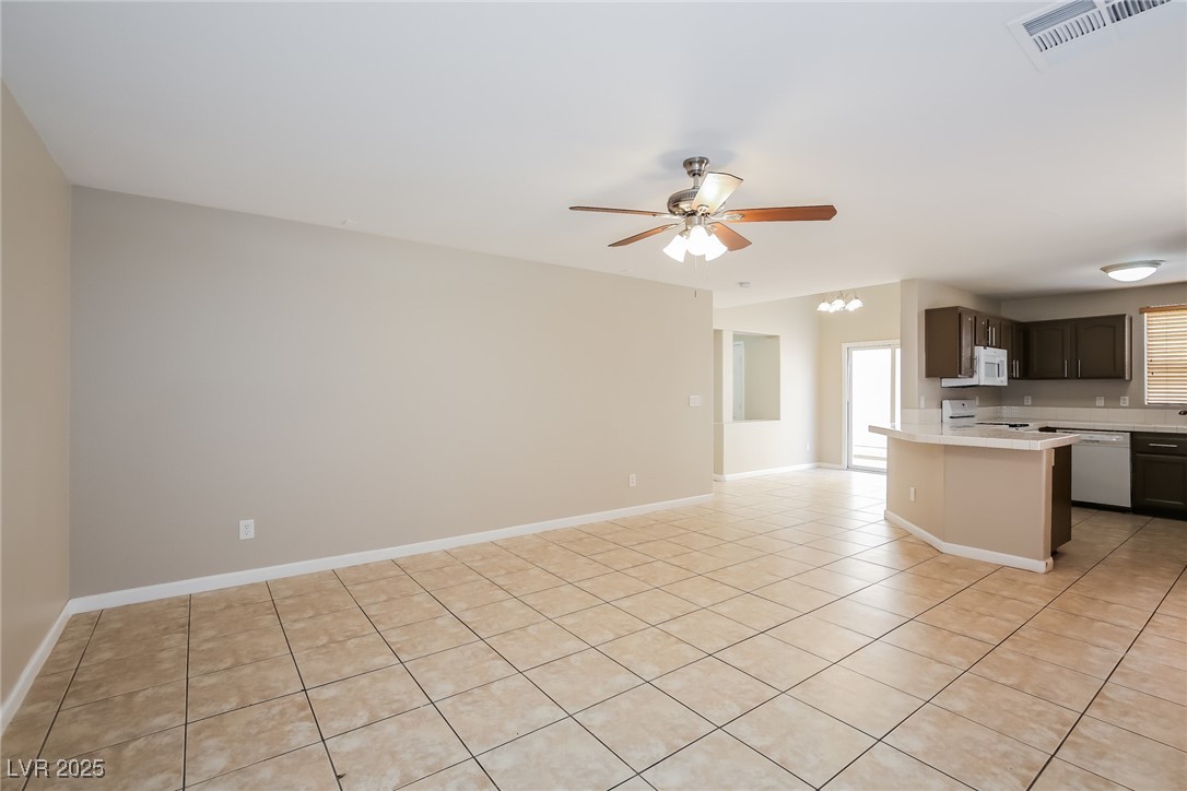 7202 Cestrum Road Las Vegas, NV 89113 - Photo 15 of 15 Kitchen with ceiling fan with notable chandelier,