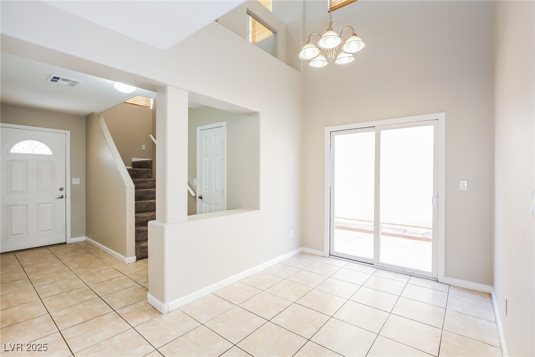 7202 Cestrum Road Las Vegas, NV 89113 - Photo 4 of 15 Entryway featuring an inviting chandelier, visible