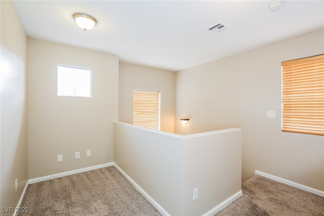 7202 Cestrum Road Las Vegas, NV 89113 - Photo 6 of 15 Corridor with carpet flooring, an upstairs landing