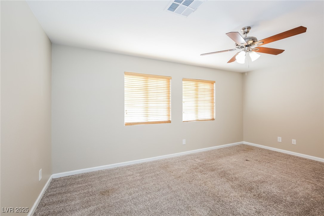 7202 Cestrum Road Las Vegas, NV 89113 - Photo 7 of 15 Spare room with baseboards, a ceiling fan, visible