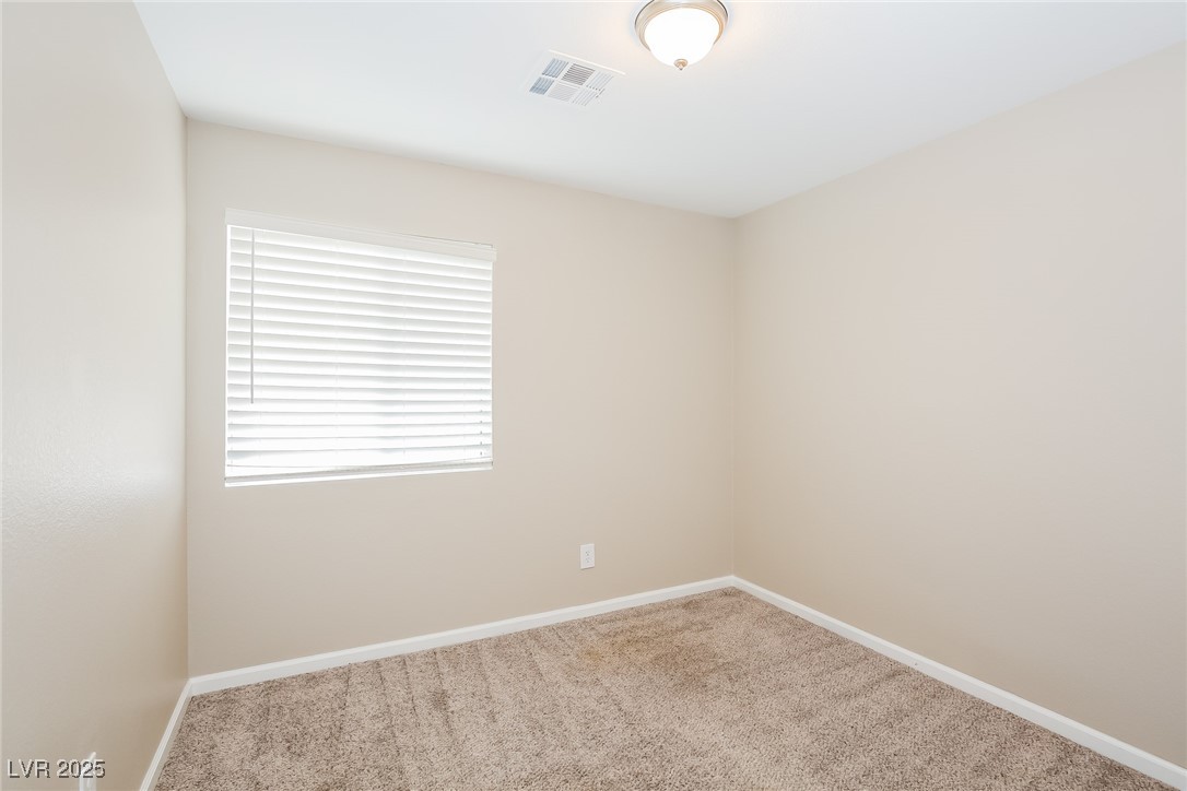 7202 Cestrum Road Las Vegas, NV 89113 - Photo 9 of 15 Carpeted empty room featuring baseboards and visib