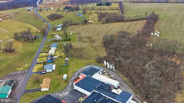 an aerial view of a houses with a yard
