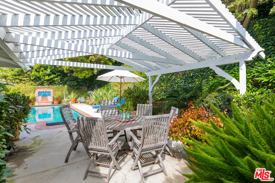 1826 Roscomare Road Los Angeles, CA 90077 - Photo 11 of 12 a patio with a patio table and chairs