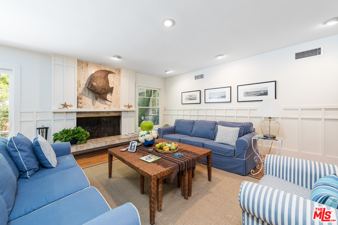 1826 Roscomare Road Los Angeles, CA 90077 - Photo 3 of 12 a living room with furniture a fireplace and a table