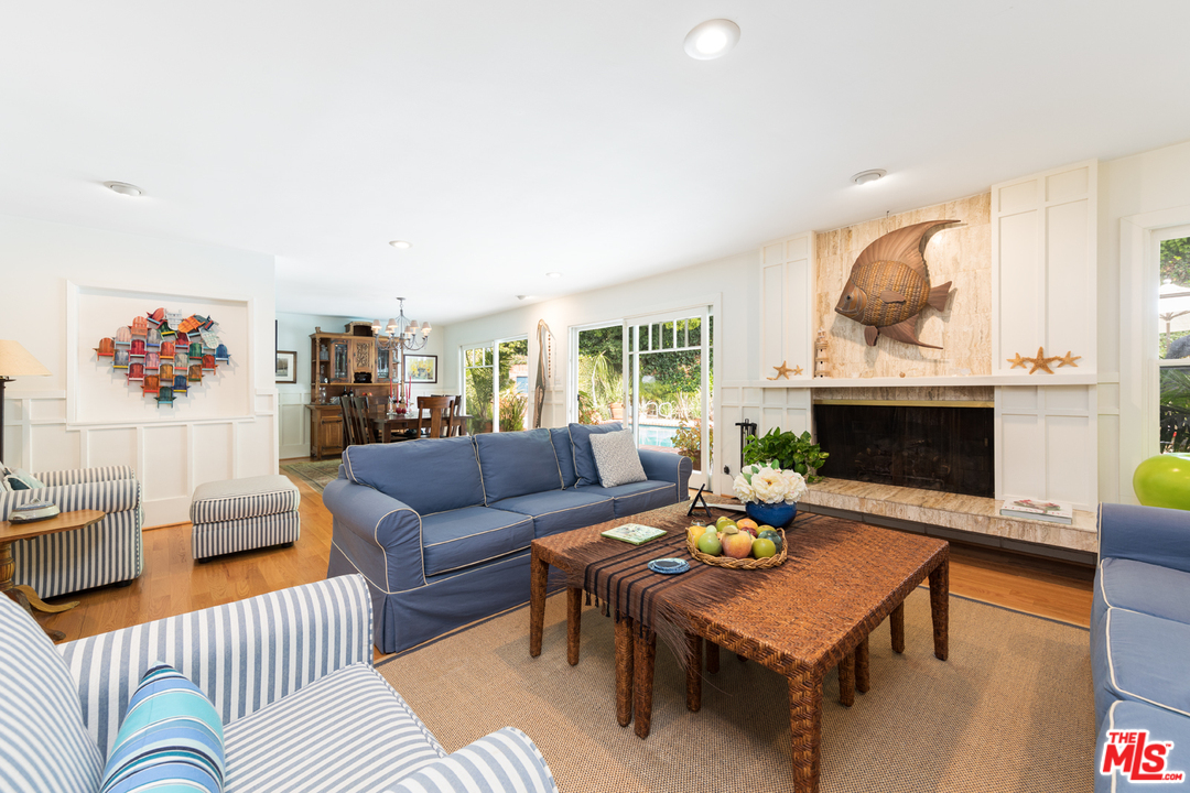 1826 Roscomare Road Los Angeles, CA 90077 - Photo 4 of 12 a living room with furniture a fireplace and a table