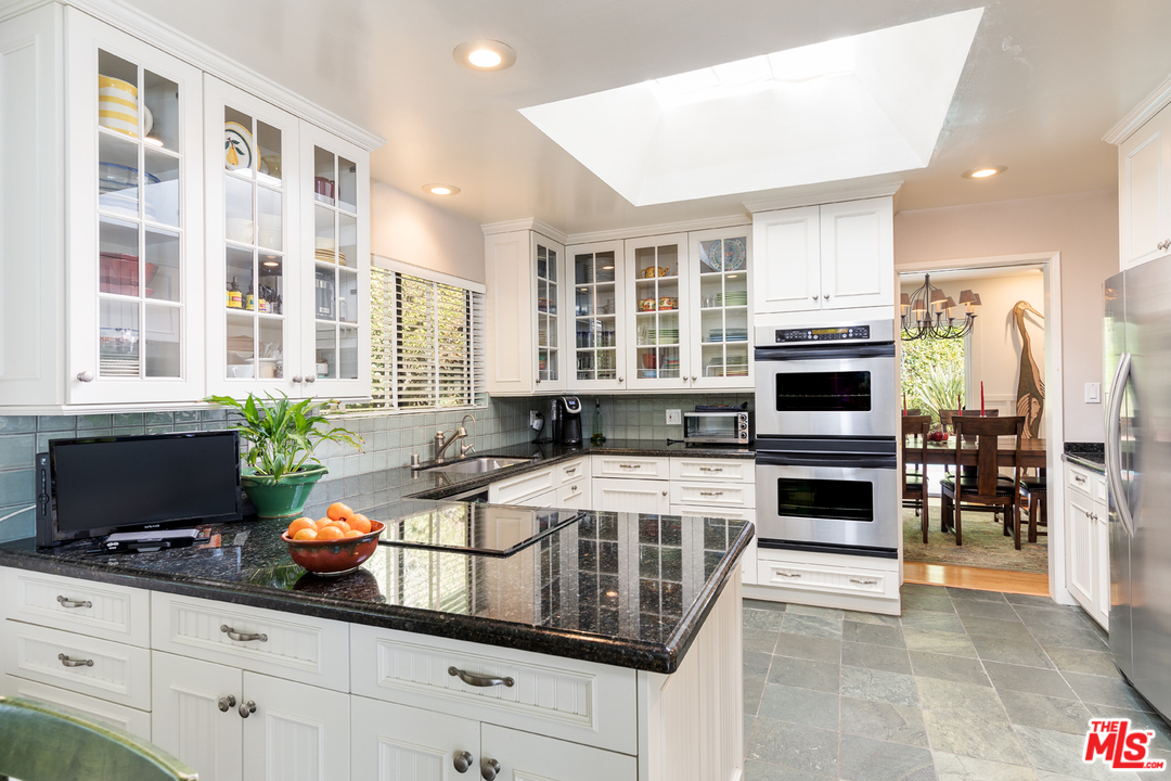 1826 Roscomare Road Los Angeles, CA 90077 - Photo 6 of 12 a kitchen with a stove a sink and a microwave