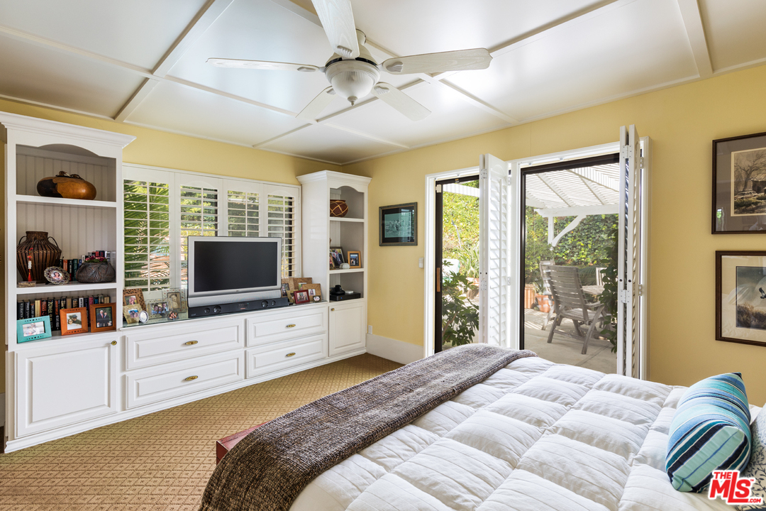 1826 Roscomare Road Los Angeles, CA 90077 - Photo 8 of 12 a bedroom with a large bed and a flat screen tv on the dresser