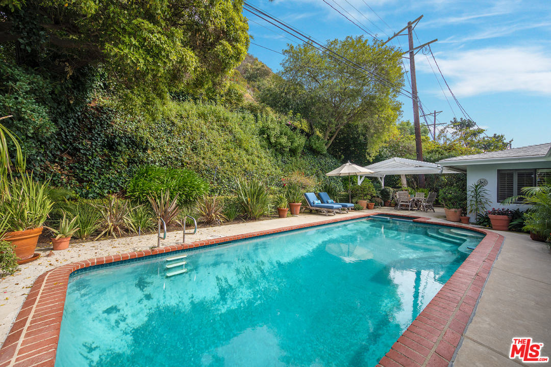 1826 Roscomare Road Los Angeles, CA 90077 - Photo 9 of 12 a view of a swimming pool with a patio