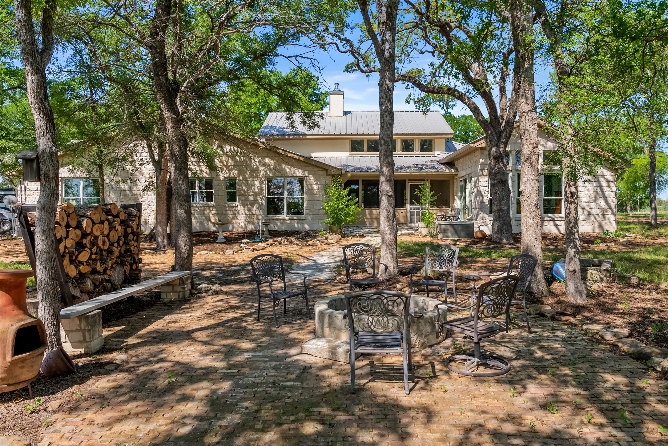 7670 Nez Perce Trace Manor, TX 78653 - Photo 18 of 40 Rear view of house featuring a chimney and metal roof