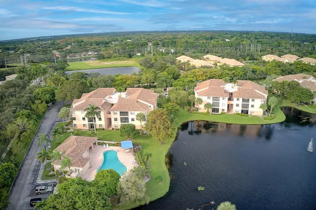 an aerial view of residential houses with outdoor space and trees