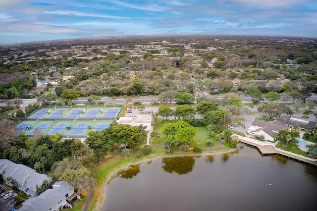 a front view of a house with a yard and potted plants