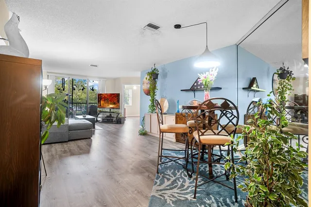 a living room with furniture and a dining area