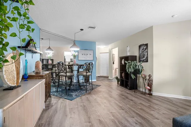 a view of a a dining room with furniture window and wooden floor