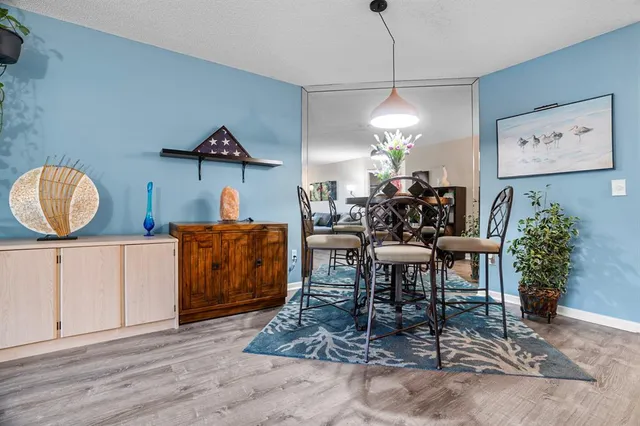 a living room with furniture a flat screen tv and a large window