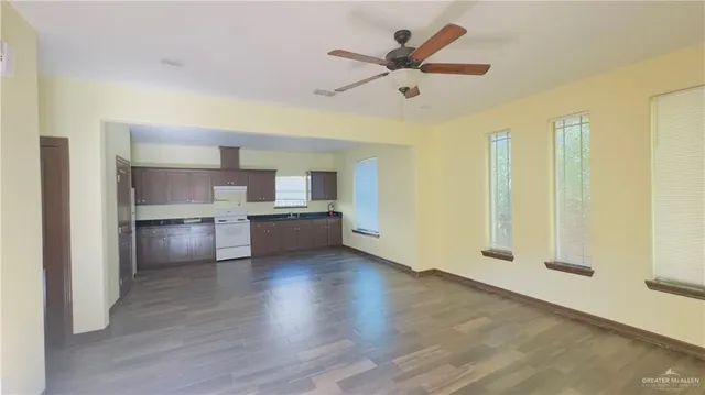 a view of a kitchen with a sink and a refrigerator