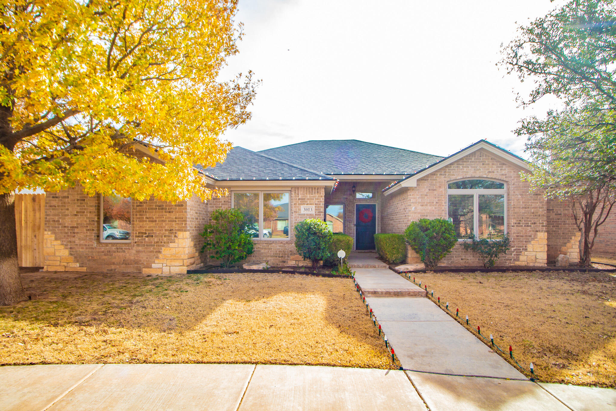 3013 110th Street Lubbock, TX 79423 - Photo 1 of 22 a front view of a house with a yard