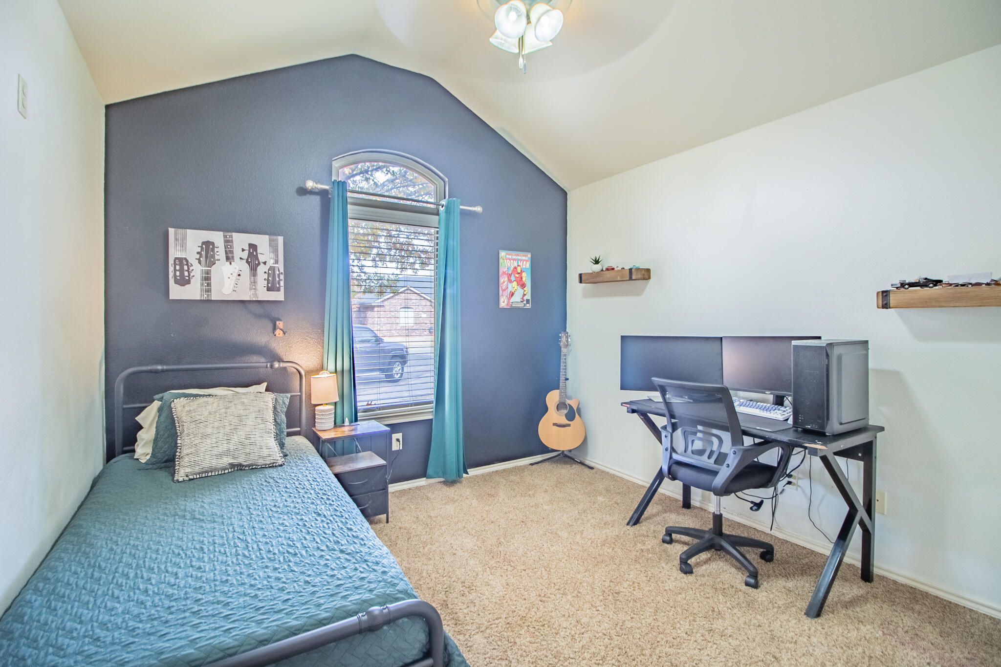 3013 110th Street Lubbock, TX 79423 - Photo 15 of 22 a bedroom with a bed a desk and chair
