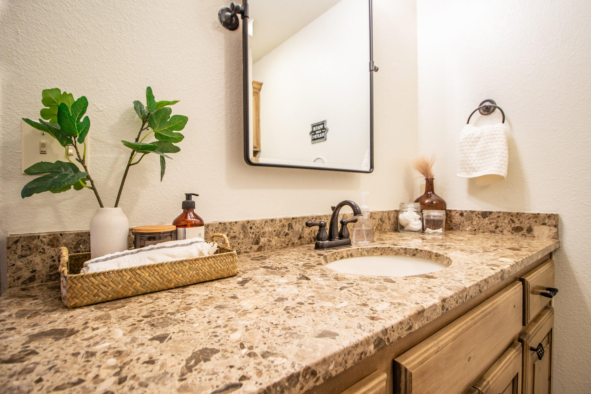 3013 110th Street Lubbock, TX 79423 - Photo 16 of 22 a bathroom with a granite countertop sink a mirror and a potted plant