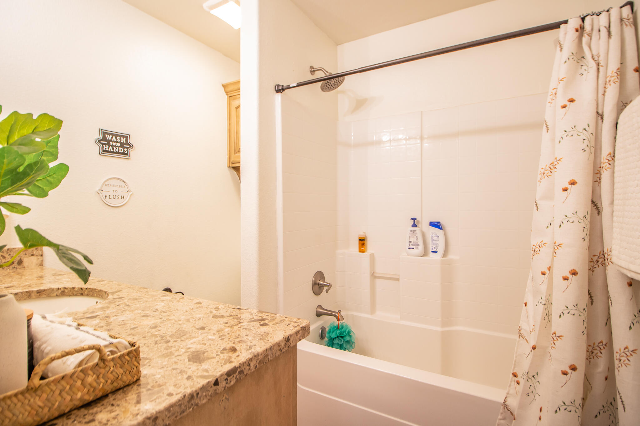 3013 110th Street Lubbock, TX 79423 - Photo 17 of 22 a bathroom with a granite countertop sink a shower and a mirror