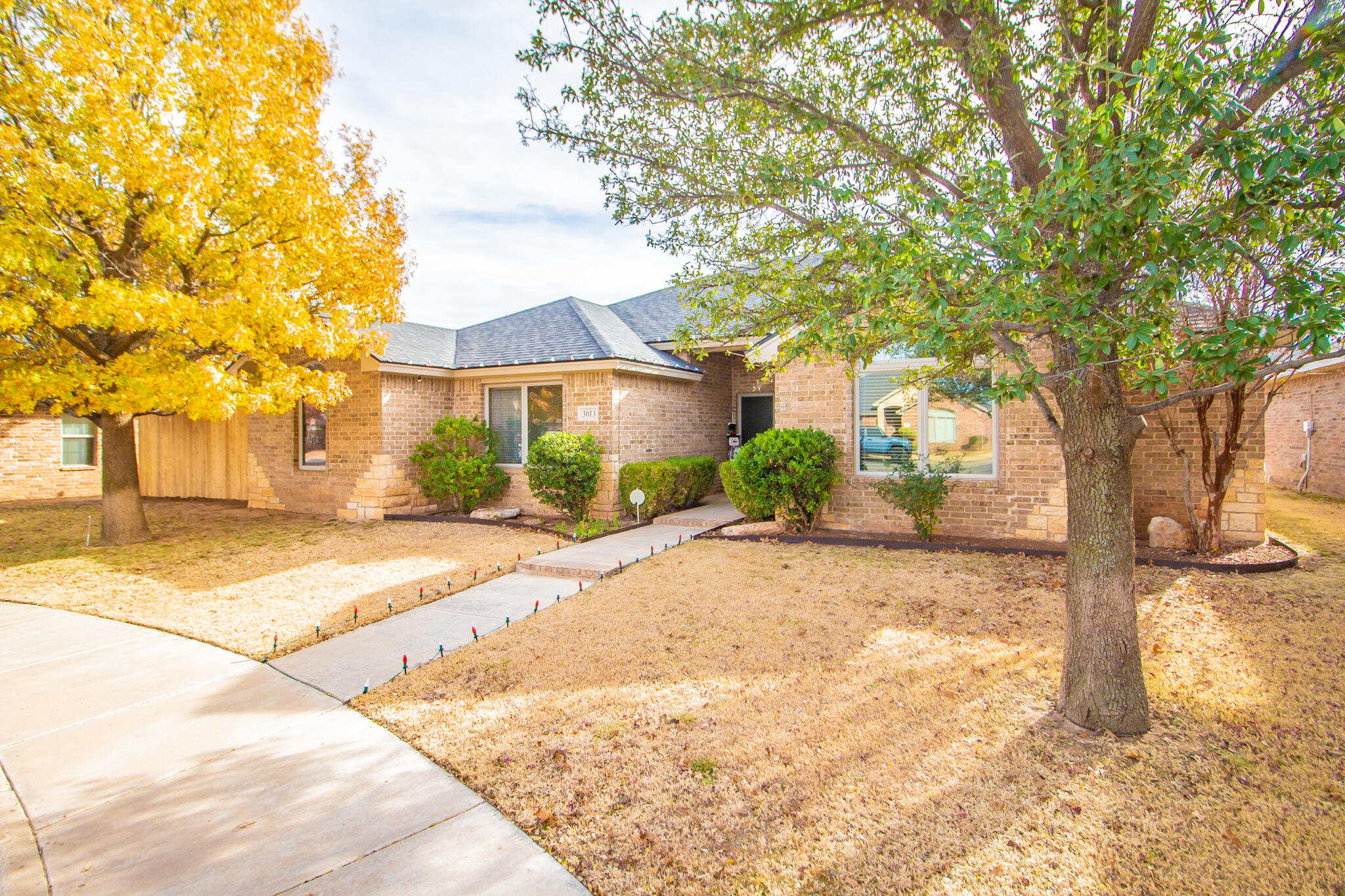 3013 110th Street Lubbock, TX 79423 - Photo 2 of 22 a view of a house with a tree in front of it