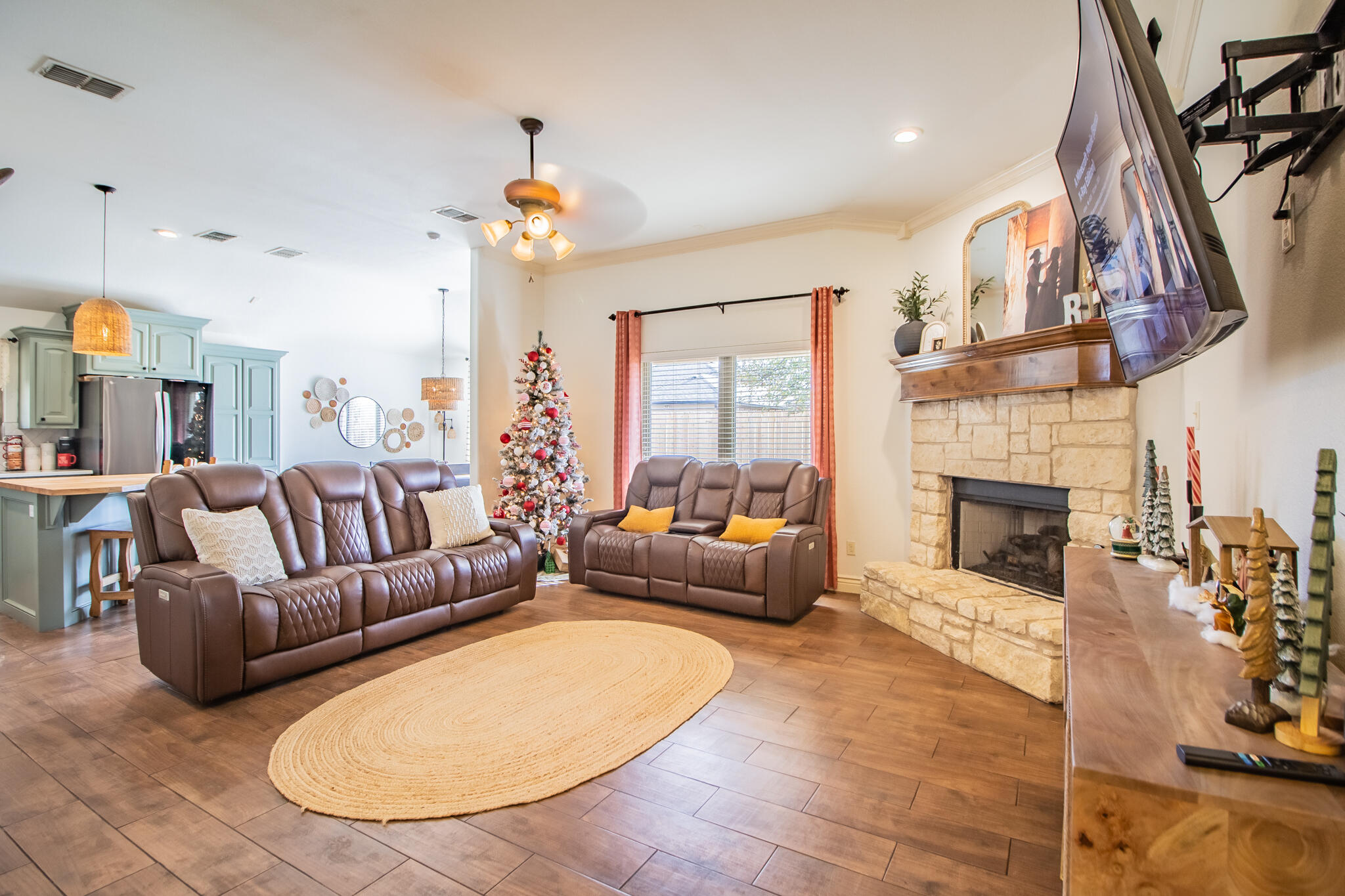 3013 110th Street Lubbock, TX 79423 - Photo 5 of 22 a living room with furniture a fireplace and a chandelier