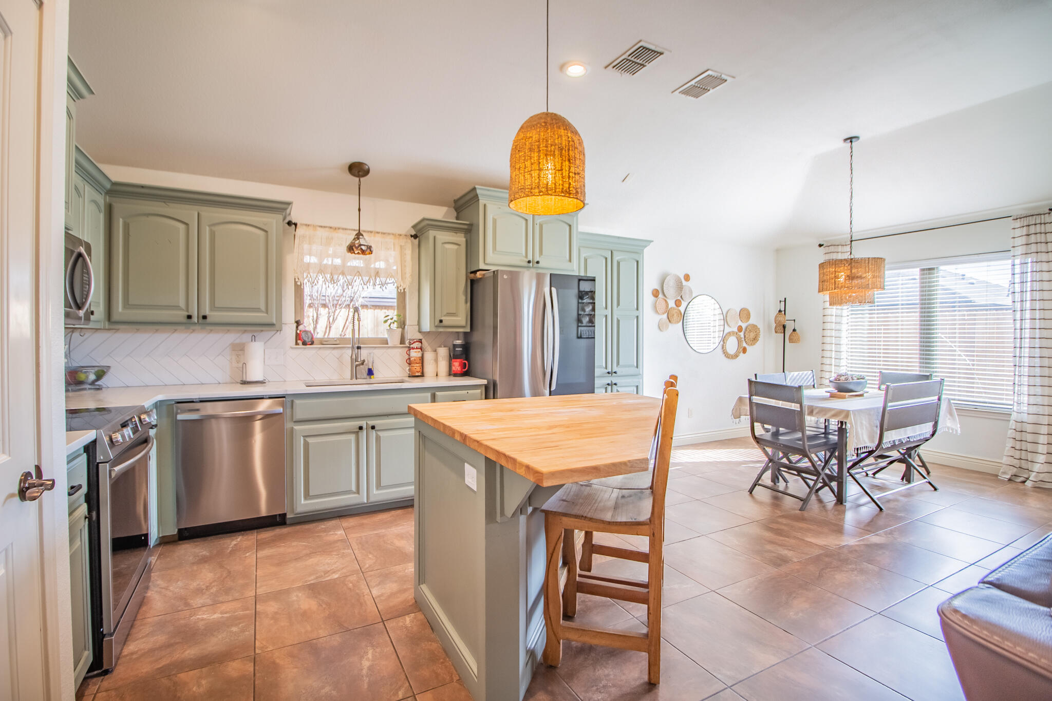 3013 110th Street Lubbock, TX 79423 - Photo 8 of 22 a kitchen with stainless steel appliances granite countertop a table chairs and a sink