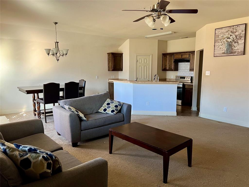 13206 Baltusral Court Dallas, TX 75253 - Photo 4 of 5 a living room with furniture and a flat screen tv