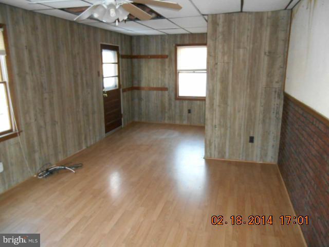 926 Martin Road Baltimore, MD 21221 - Photo 8 of 15 an empty room with wooden floor and windows