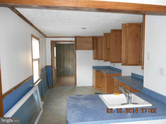 926 Martin Road Baltimore, MD 21221 - Photo 10 of 15 a view of a hallway to an empty room with wooden floor and a window